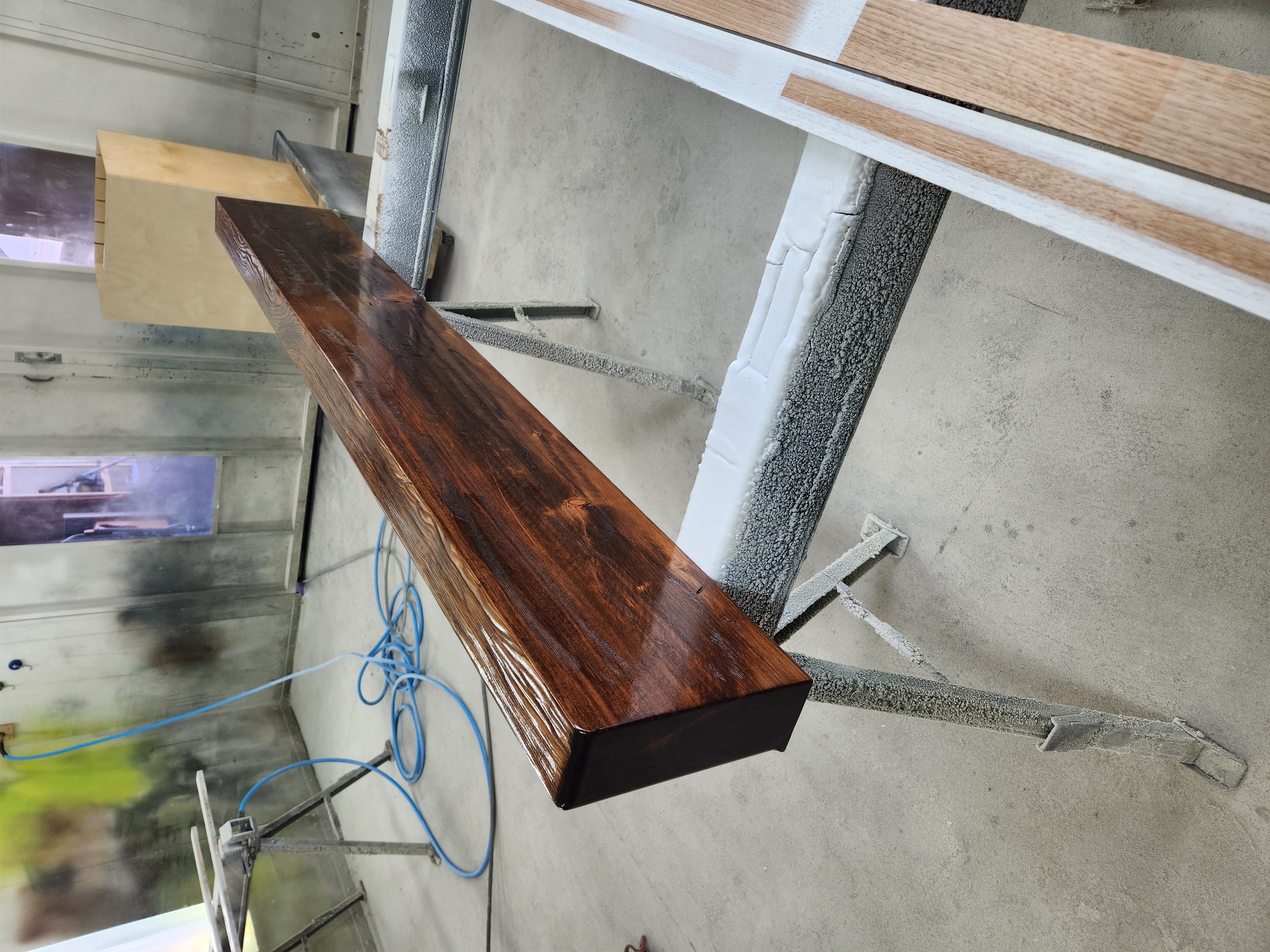 Dark walnut beam on sawhorses